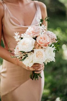 a woman in a dress holding a bouquet of flowers