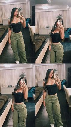 a woman taking a selfie while wearing green pants and a black cropped top