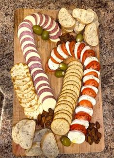 a wooden cutting board topped with different types of food