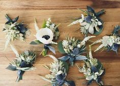 flowers are arranged on a wooden cutting board