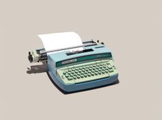 an old - fashioned typewriter with a sheet of paper on it's side