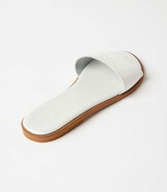 Elevate your style effortlessly with the simplicity of chic fashion in these versatile slide sandals, allowing you to pair them with anything from casual denim to a breezy summer dress. Whether you're strolling through the city streets or enjoying a leisurely day at the beach, these comfortable leather sandals are made for your every adventure. 100% Leather Imported Soft pillow sole Runs small and narrow; we recommend sizing up Rub with dry cloth | Karen Kane Leather Sandals in White, Size 36, P White Adjustable Sandals For Everyday Wear, Casual Summer Sandals With Leather Footbed, Summer Sandals With Cushioned Footbed, Spring Mules For Everyday Use, Casual Mules With Textured Sole For Spring, White Leather Slides For Spring, Casual Slides With Flat Heel For Spring, Casual Spring Mules With Textured Sole, Modern White Beach Mules