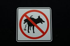 a no dogs allowed sign on a black background