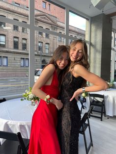 two girls in formal wear posing for the camera