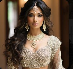 a woman wearing a bridal outfit and jewelry