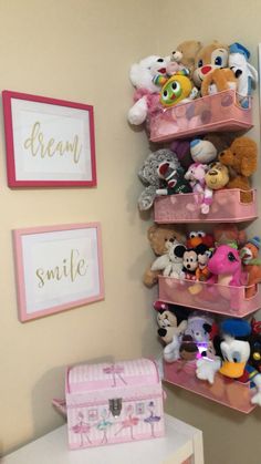 a pink shelf filled with lots of stuffed animals