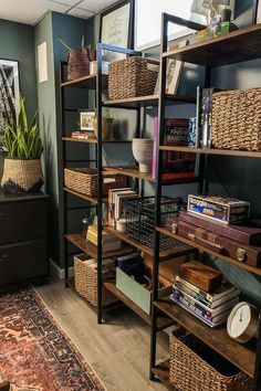 a bookshelf filled with lots of books and baskets