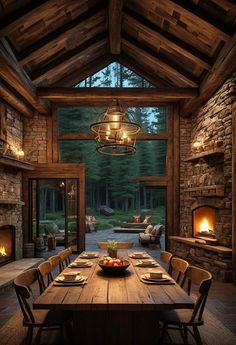 a rustic dining room with stone fireplace and wooden table