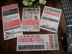 wedding stationery with guitar and flowers on the table next to it's concert ticket