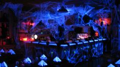 the bar is decorated with blue lights and spider webs