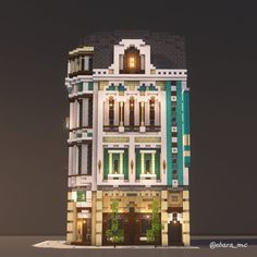 a building made out of legos is shown in the night time with its lights on