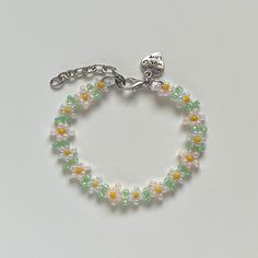 "Handmade Beaded Bracelet ✿ Made with glass seed beads and metal accents ✿ Milky white, soft peach, yellow, and sea-foam green ✿ The bracelet has 1.5\" of extension chain" White Spring Jewelry With Tiny Beads, Spring White Jewelry With Tiny Beads, Green Beaded Chain Bracelets For Jewelry Making, Green Beaded Chain Bracelet For Jewelry Making, Spring Beaded Pearl Bracelet With Round Beads, Spring Beaded Adjustable Pearl Bracelet, Adjustable Beaded Crystal Bracelet For Spring, Spring Adjustable Beaded Pearl Bracelet, Adjustable Beaded Pearl Bracelet For Spring