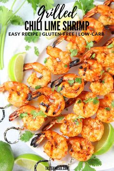 grilled shrimp on a plate with limes and cilantro