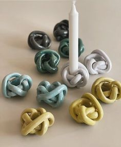 an assortment of rings next to a candle