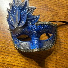 New Masquerade Mask From New Orleans. Blue Silver And Gold Details. 6” Wide 7” Tall At Highest Point. 3” Tall On Right Side. Blue Masquerade Outfit, Blue Mask Masquerade Ball, Masquerade Ball Masks Blue, Blue And White Masquerade Mask, Blue And Gold Masquerade Mask, Peacock Outfit, Blue Eye Mask For Carnival Masquerade, Masquerade Ball Aesthetic, Masquerade Mask Blue Silver