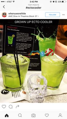 two green cocktails sitting on top of a table