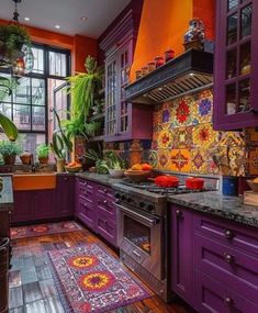 a kitchen with purple cabinets and an area rug in front of the stove top oven