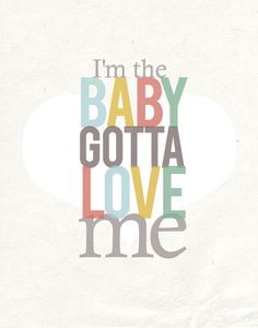 i'm the baby gota love me quote on white paper with multicolored letters