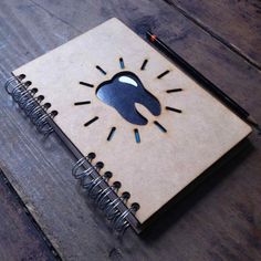 a spiral notebook with an image of a person's head on it