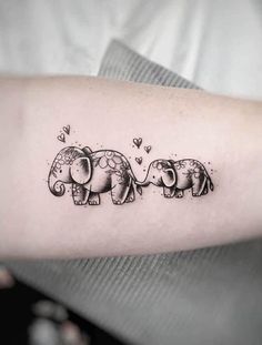 an elephant couple tattoo on the arm