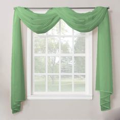 a window with green drapes hanging from it's side