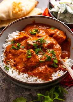 a bowl filled with rice and meat curry