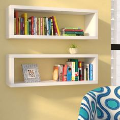 two white shelves with books on each shelf