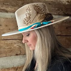 Rancher style cowboy hat for cowgirls custom burned by hand exclusively for Bourbon Cowgirl! Honoring Lainey Wilson and her new song Wild Flowers and Wild Horses! We worked with this popular designer to create our very own look. 100% wool rancher hat in oatmeal which is a neutral ivory color. One size fits all, as the interior band is adjustable to fit most. A beautiful rancher style with a pinch crease, this gorgeous creamy neutral cowgirl hat is sanded and torched to a beautifully burnished an Fitted Southwestern Hat For Western-themed Events, Western Fedora With Flat Crown, Rustic Felt Hat For Rodeo, Rustic Fitted Felt Hat For Rodeo, Rustic Handmade Adjustable Felt Hat, Fedora For Country Events With Flat Crown, Artisan Style Brimmed Hats For Ranch, Rustic Fitted Fedora With Flat Brim, Rustic Fitted Hat For Western-themed Events