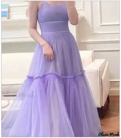 a woman in a long purple dress is taking a selfie with her cell phone