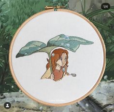 a cross stitch pattern with a little mermaid under a leaf