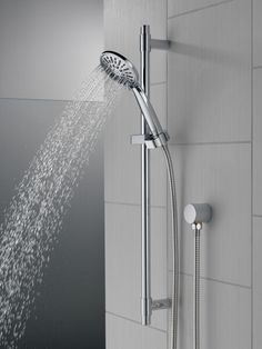 the shower head is open and running with water coming from it's spout