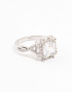 a white gold ring with an oval cut diamond surrounded by small diamonds