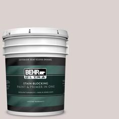 a yellow paint bucket with the label behr ultra stain and primer in one