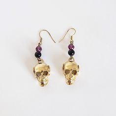 "This pair is sure to make a statement.   Don't let go of your gothic side. Hang on to your metal music.   Because RECOVERY ROCKS Style #1114 Beaded Earring Ear Wires are Surgical Stainless Steel Clear Faceted Acrylic Bead or a purple faceted bead with a black ball 3d Skull with Alcoholics Anonymous AA Symbol in a Small Twist Wire Alcoholics Anonymous AA Circle Triangle Symbol on Both Sides Antique Brass Finish 5/8\" Wide by 1-3/8\" Tall not including Ear Wire With each pair of earrings, we incl Alternative Metal Earrings For Party, Adjustable Gothic Skull Earrings, Alternative Style Metal Earrings For Party, Gothic Skull Earrings For Party, Alternative Style Halloween Gift Earrings, Punk Halloween Festival Earrings, Aa Symbol, Recovery Jewelry, Triangle Symbol