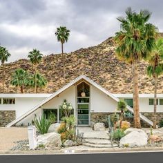 a white house with palm trees in front of it