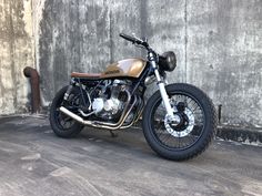 a motorcycle parked in front of a concrete wall