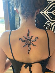 a woman with a sun tattoo on her back