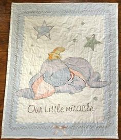 a baby quilt with an elephant on it that says, our little minooe