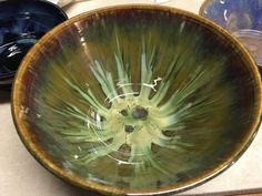 a green bowl sitting on top of a counter