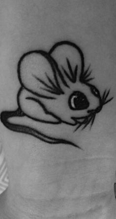 a woman's stomach with a mouse tattoo on it