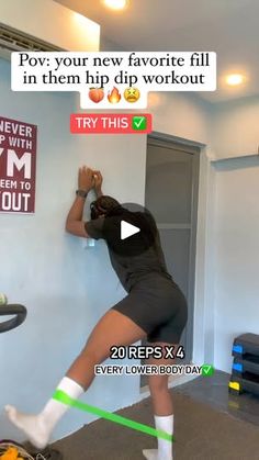 a woman is doing exercises on the wall