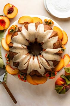 a bundt cake with sliced peaches and icing