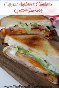 a cut in half sandwich sitting on top of a cutting board