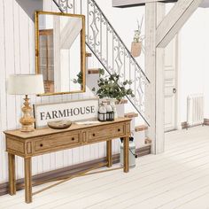 a wooden table topped with a mirror and vase filled with flowers next to a stair case