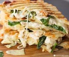 a stack of grilled cheese and spinach quesadilla stacked on top of each other