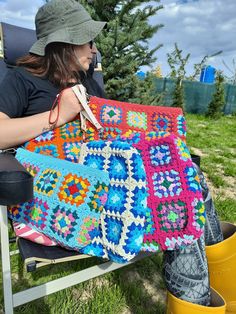 Colorful granny square crochet bag in boho style. It can also be used as a make-up bag or cosmetic bag. 📌100% handmade 📌Lined and zippered 📌I used washable cotton threads 📌You can wash your bag in the delicate section. 📌Bag color may vary slightly depending on different monitor settings. 📌Information About Shipping: Please note that delivery times may vary depending on customs clearance in your country and unforeseen delays. You can also check out my other products in my store👇 https://ae Bohemian Festival Bag With Granny Square Details, Bohemian Granny Square Bag For Festival, Bohemian Granny Square Crochet Bag, Handmade Rectangular Crochet Bag For Festival, Handmade Hippie Rectangular Bag, Bohemian Blue Crochet Bag With Granny Square, Bohemian Crochet Bag With Granny Square Design, Square Crochet Bags For Festivals, Bohemian Granny Square Crochet Bag For Crafting