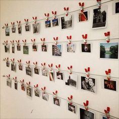 a bunch of pictures hanging on a wall with magnets attached to it and red bows