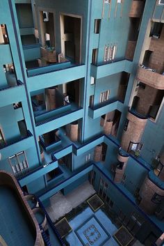 an aerial view of the inside of a building with blue walls and balconies