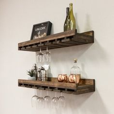 two wooden shelves holding wine glasses and bottles