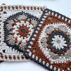 two crocheted coasters sitting next to each other on top of a table